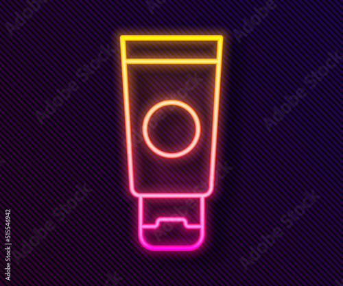 Glowing neon line Cream or lotion cosmetic tube icon isolated on black background. Body care products for men. Vector