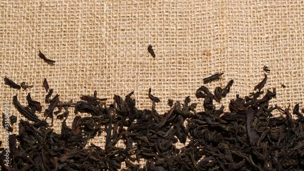 Close-up herbal black or green tea leaves texture on jute sack, food ...