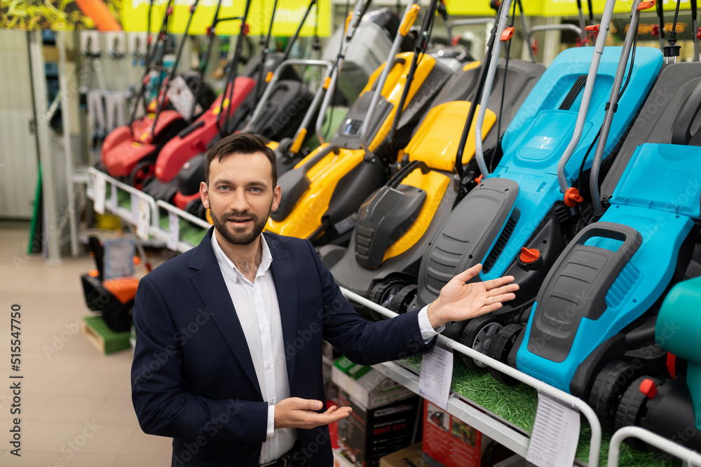 Fototapeta premium garden equipment store manager offers a wide range of lawn mowers