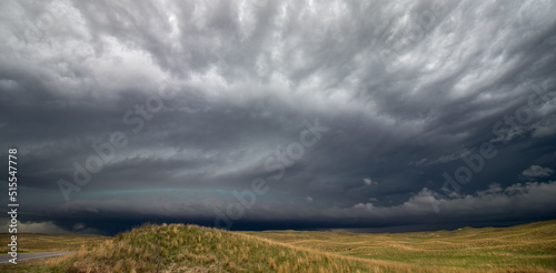A huge supercell thunderstorm fills the sky over the sand hills region of Nebraska.