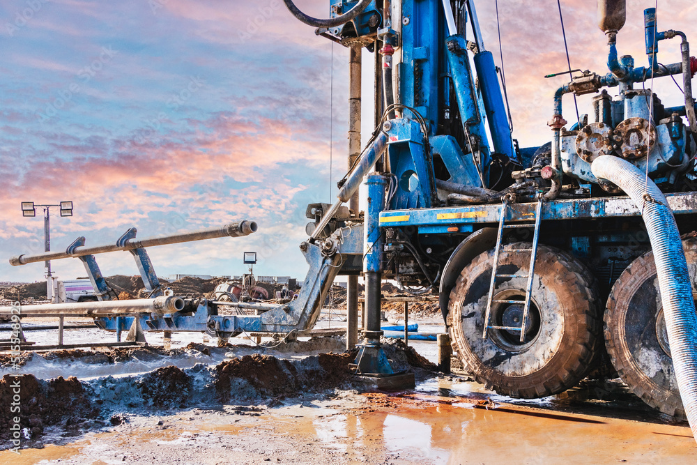 Close-up of a car-based drilling rig at a construction site. Drilling deep wells for mining.. Working process of drilling a well. Close-up of a car-based drilling rig at a construction site. Drilling deep wells for mining.. Working process of drilling a well.