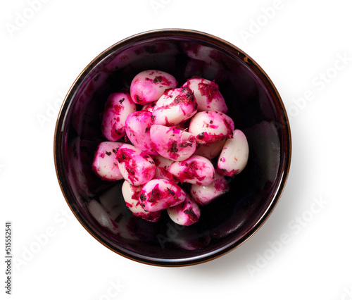 Pickled shiso garlic served on a plate set against a white background. photo