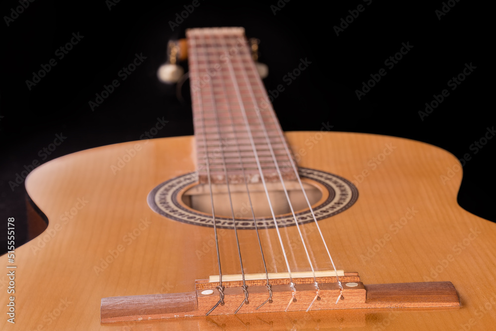 Obraz premium Fragment of soundboard of wooden acoustic guitar in selective focus