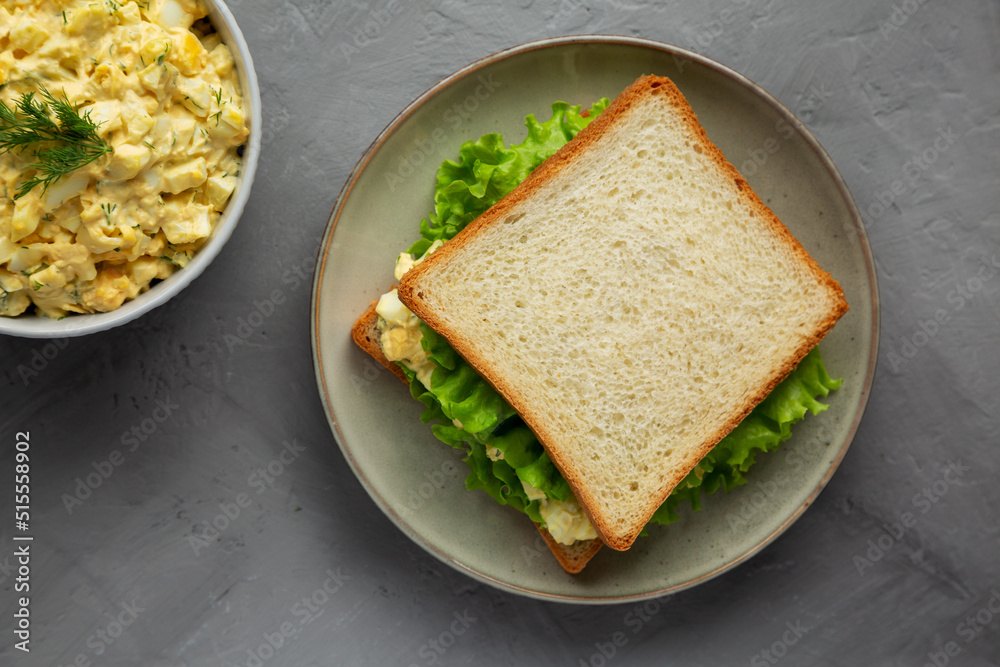 Homemade Egg Salad Sandwich with Lettuce on a Plate, top view. Flat lay, overhead, from above. Homemade Egg Salad Sandwich with Lettuce on a Plate, top view. Flat lay, overhead, from above.