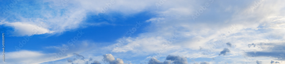 Fototapeta premium Blue sky with beautiful clouds and sunlight, banner format