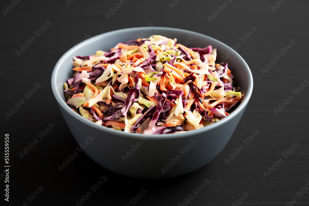 Homemade Coleslaw with Cabbage and Carrots in a Bowl, low angle view. Close-up. Homemade Coleslaw with Cabbage and Carrots in a Bowl, low angle view. Close-up.