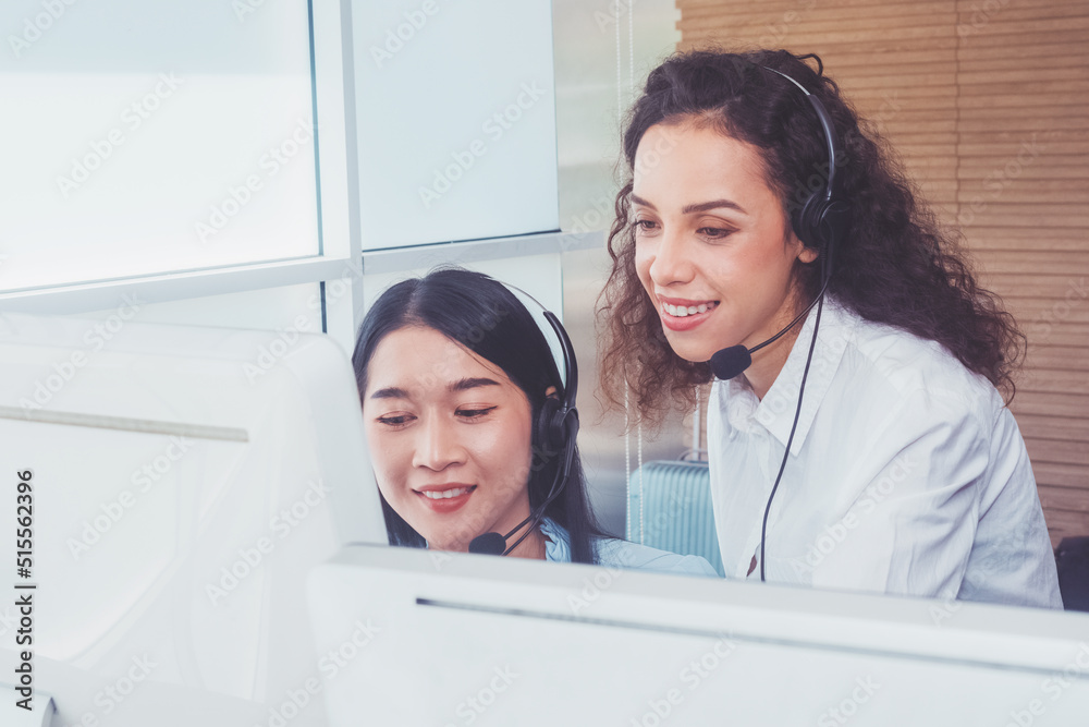 Women team call center workers in headphones are working at modern office. Women team call center workers in headphones are working at modern office.