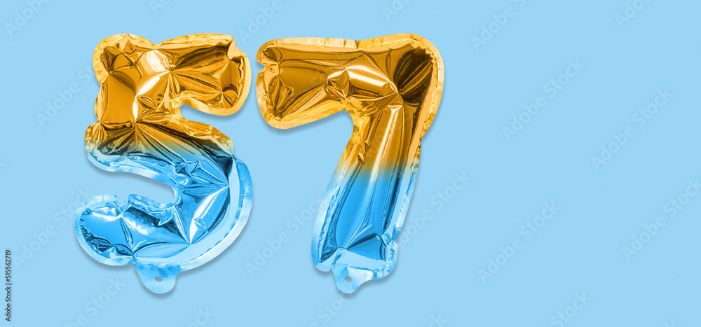 Rainbow foil balloon number, digit fifty seven on a blue background. Birthday greeting card with inscription 57. Top view. Numerical digit. Celebration event, template. Banner Rainbow foil balloon number, digit fifty seven on a blue background. Birthday greeting card with inscription 57. Top view. Numerical digit. Celebration event, template. Banner