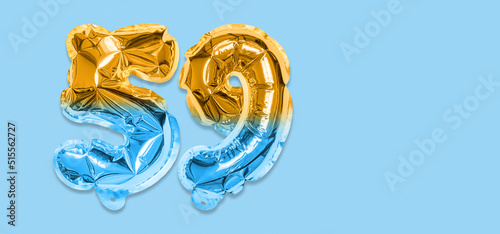 Rainbow foil balloon number, digit fifty nine on a blue background. Birthday greeting card with inscription 59. Top view. Numerical digit. Celebration event, template. Banner photo
