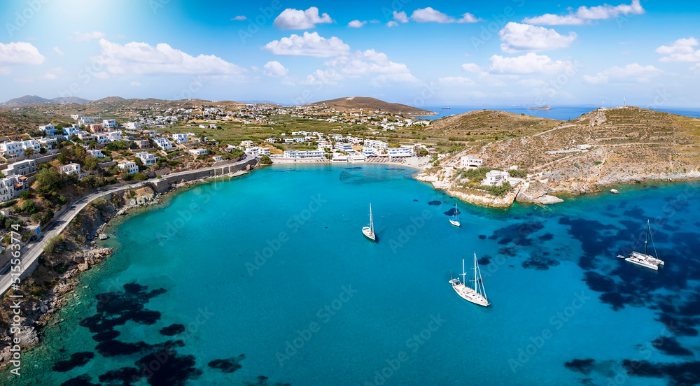 Panoramic aerial view of the popular beach at Vari, Syros island, Greece, with sailboats moored over the turquoise sea