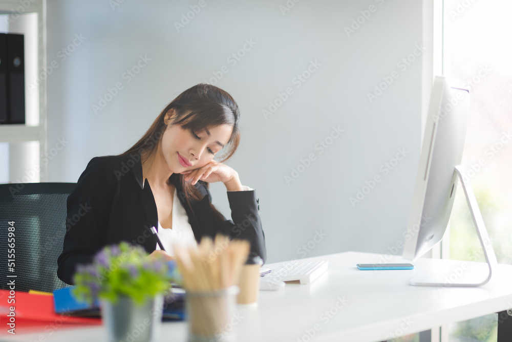 Business Asian woman working and writing planning on desk in modern office workspace room. Business Asian woman working and writing planning on desk in modern office workspace room.
