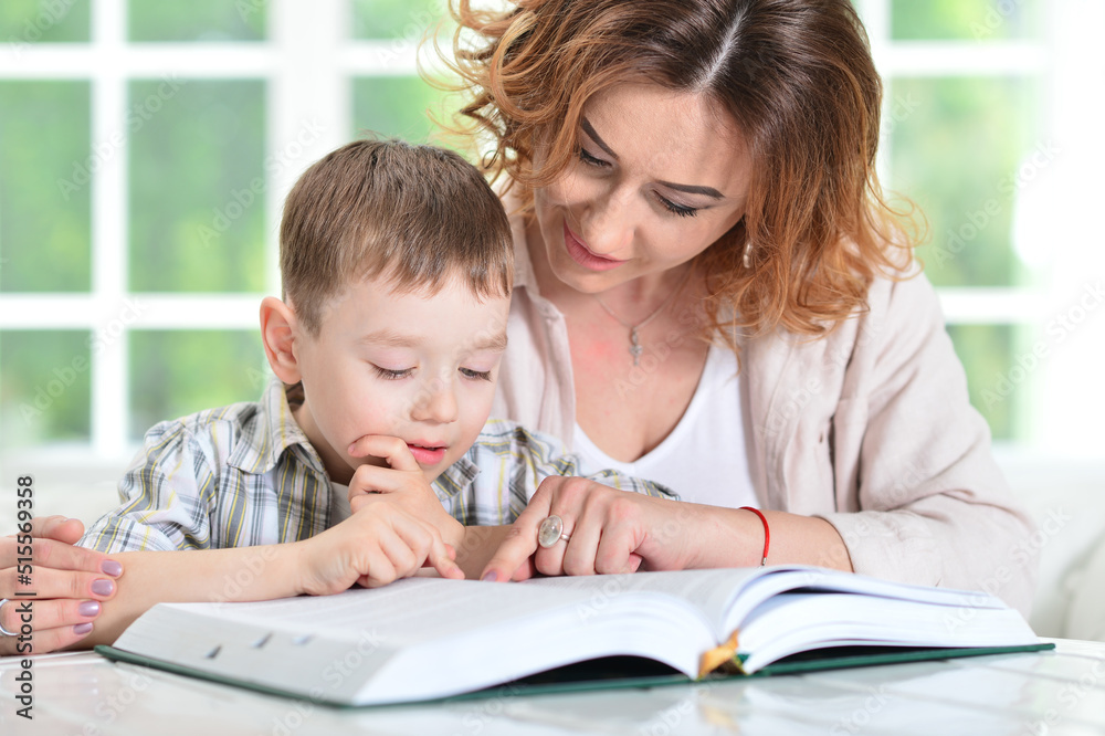 Mother with her son doing homework at home Mother with her son doing homework at home