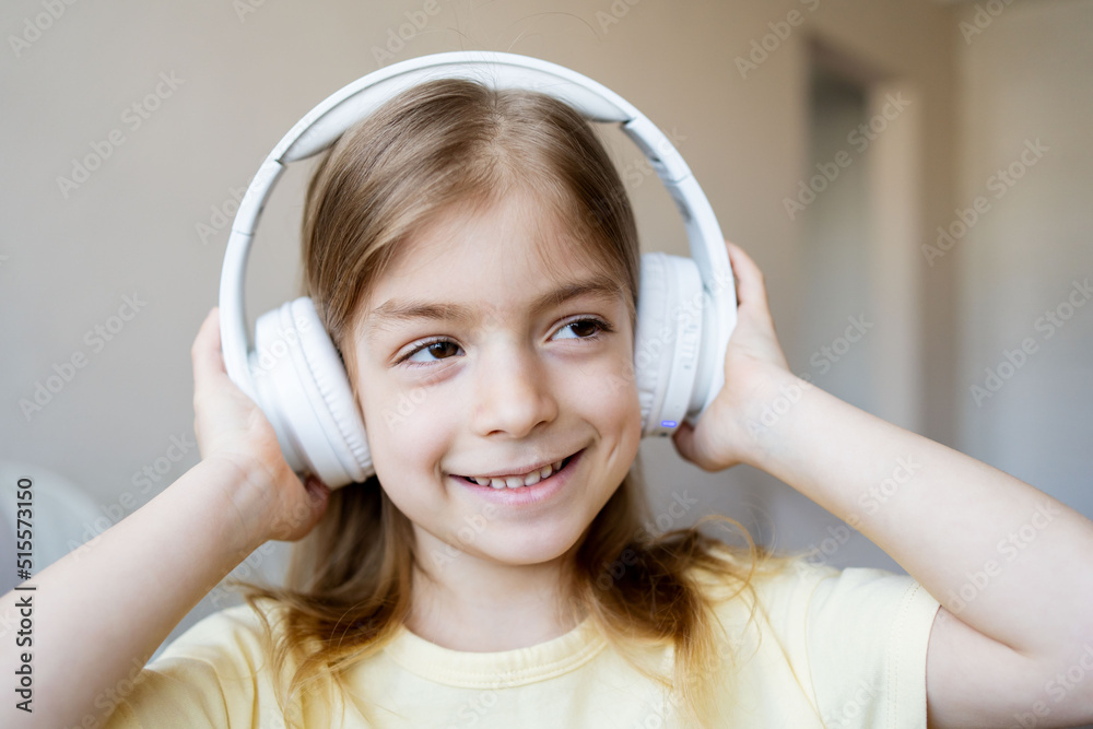 Cute child using headphones at home. Little kid girl having fun at home. Childhood concept. Cute child using headphones at home. Little kid girl having fun at home. Childhood concept.