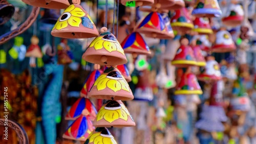 Ceramic handycrafts sold in the shops sold in Sopot Poland. Candid authentic souvenir travel idea gifts. Clay bells hang on a rope. Shallow depth of field photo