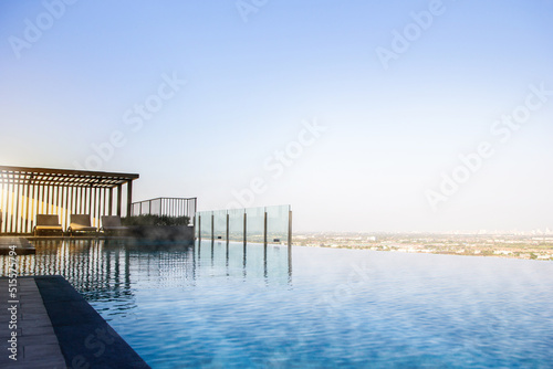 Sky swimming pool background, Cool Rooftop infinity pool background, 
Infinite rooftop pool overlooking the sky and clouds.