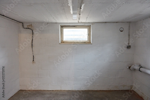 Empty room in the basement with a window as a boiler room photo