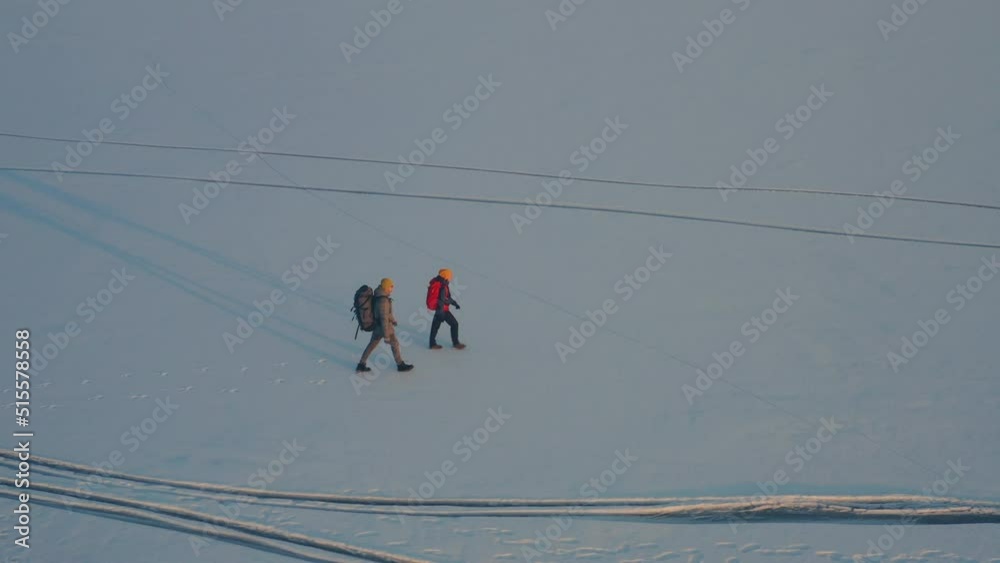 The man and woman going through the icy snow field The man and woman going through the icy snow field