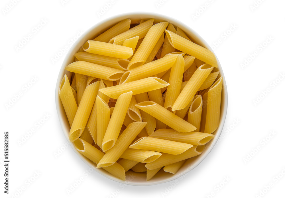 Penne pasta isolated on white background, uncooked pasta on a wooden table Penne pasta isolated on white background, uncooked pasta on a wooden table