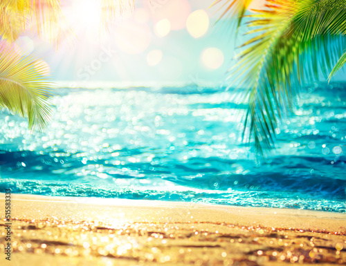 Summer Beach - Defocused Sea With Blurred Palm Leaves And Bokeh Lights On Ocean - Golden Sand In Abstract Landscape