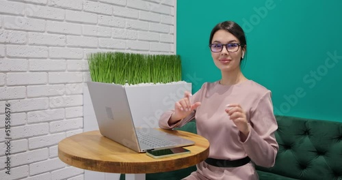 Girl works works at the computer laptop shows the sign of the heart