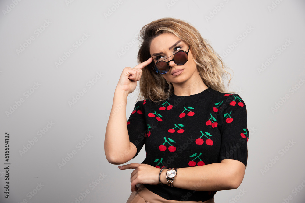 Young woman with glasses posing on gray background Young woman with glasses posing on gray background
