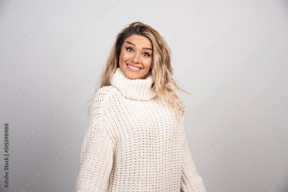 Beautiful woman in winter outfit smiling happily Beautiful woman in winter outfit smiling happily