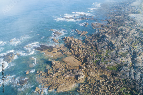 Fototapeta Naklejka Na Ścianę i Meble -  aerial view of waves on coastal rocks