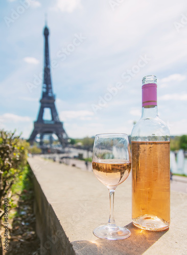 Wine in a glass near the eiffel tower. Selective focus.