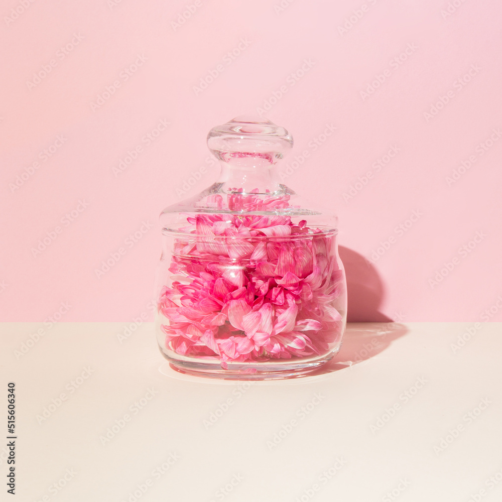 Closed glass bowl with flower petals. Pastel background. Aromatherapy. Closed glass bowl with flower petals. Pastel background. Aromatherapy.