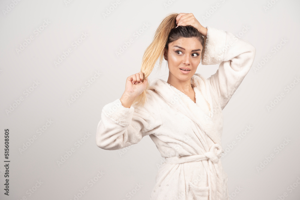 Beautiful young woman posing in a robe Beautiful young woman posing in a robe