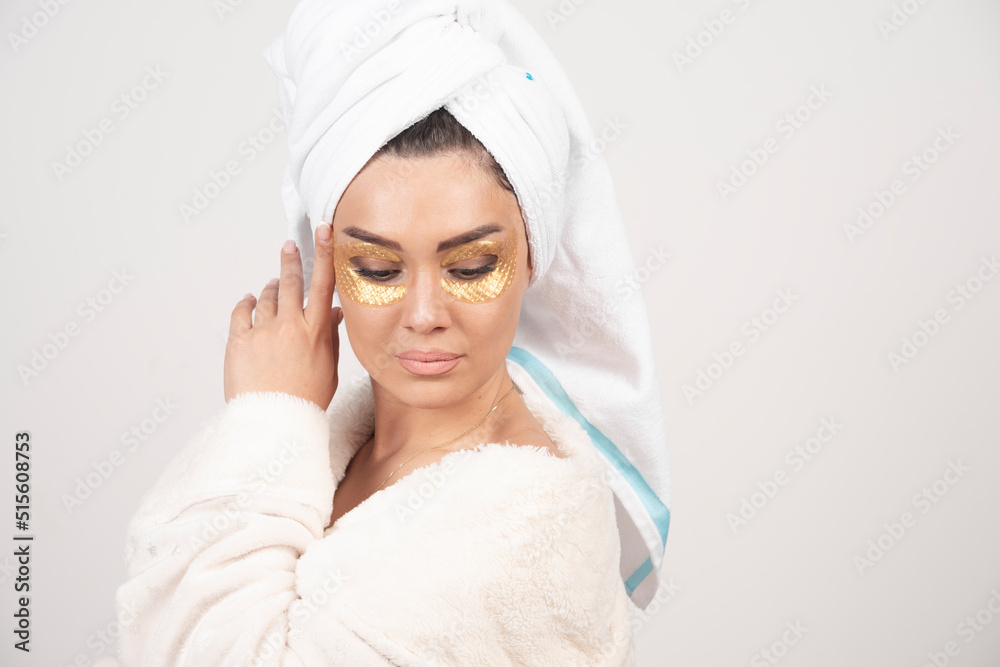 Photo of a woman looking down with hydrogel eye patches Photo of a woman looking down with hydrogel eye patches