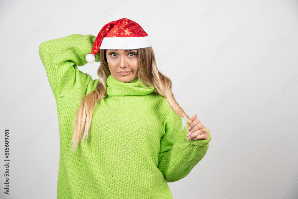 Young woman posing in Santa Claus red hat