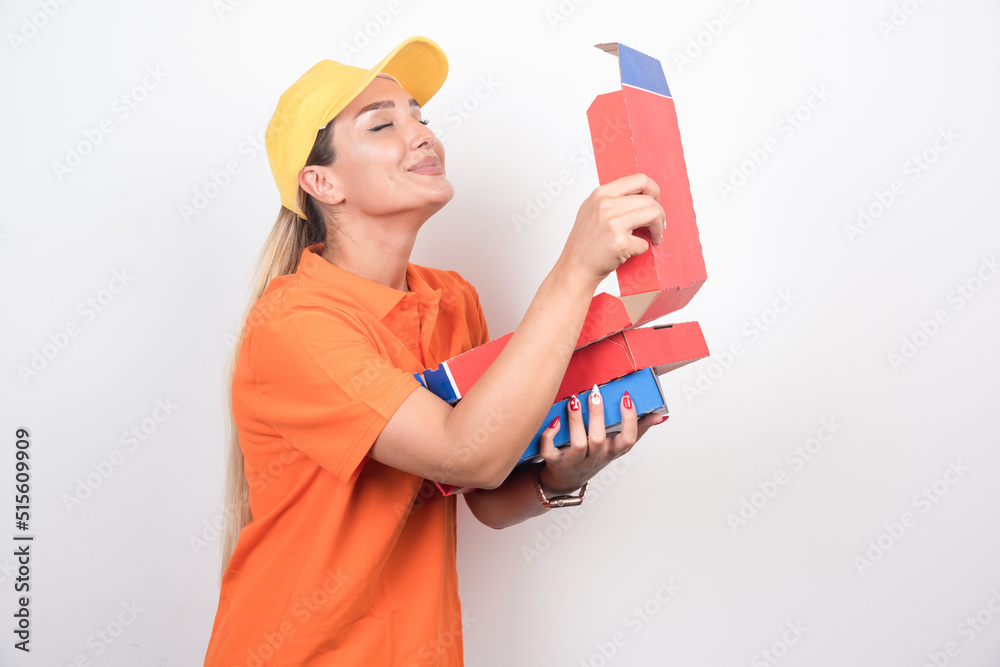 Pizza delivery woman opening pizza box with happy face on white background Pizza delivery woman opening pizza box with happy face on white background
