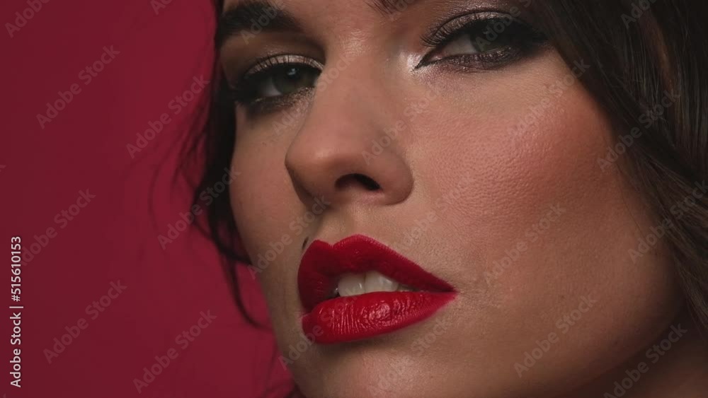 Beautiful woman with curls and red lips posing in the studio Beautiful woman with curls and red lips posing in the studio