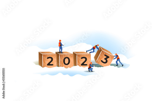 Working little men build cubes. Cute miniature teamwork. Tiny characters make up the word "2023" in snow. Worker team create wooden block number 2023, Happy new year concept. Realistic 3d vector