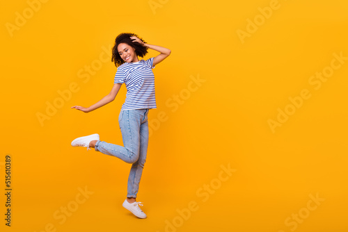 Full length portrait of satisfied adorable person toothy smile empty space ad isolated on yellow color background