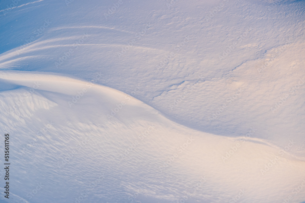 Beautiful winter background with snowy ground. Natural snow texture. Wind sculpted patterns on snow surface. Beautiful winter background with snowy ground. Natural snow texture. Wind sculpted patterns on snow surface.