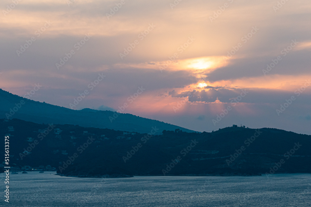 Fototapeta premium Ksamil, Albania The view over towrds Corfu, Greece and the Ionian islands at sunset