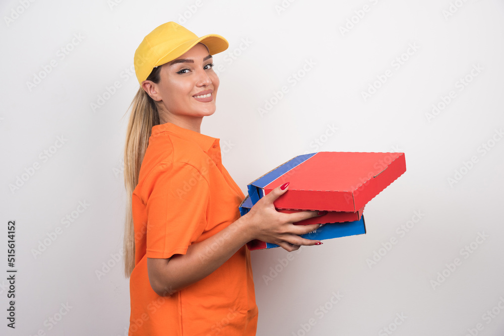 Pizza delivery woman holding pizza boxes with peaceful face on white background Pizza delivery woman holding pizza boxes with peaceful face on white background