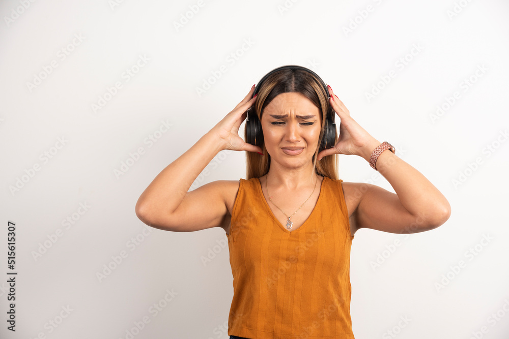 Young woman girl in casual clothes posing with headphones Young woman girl in casual clothes posing with headphones