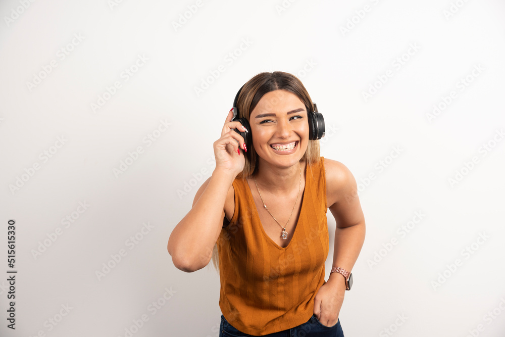 Young woman girl in casual clothes posing with headphones Young woman girl in casual clothes posing with headphones