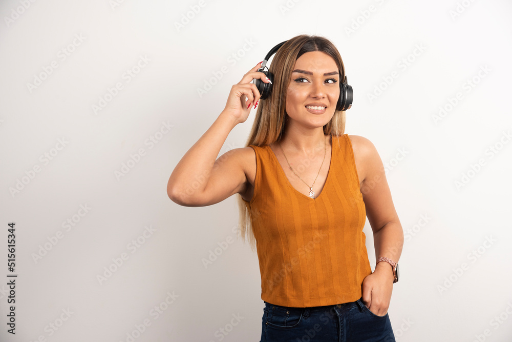 Pretty woman wearing headphones on white background