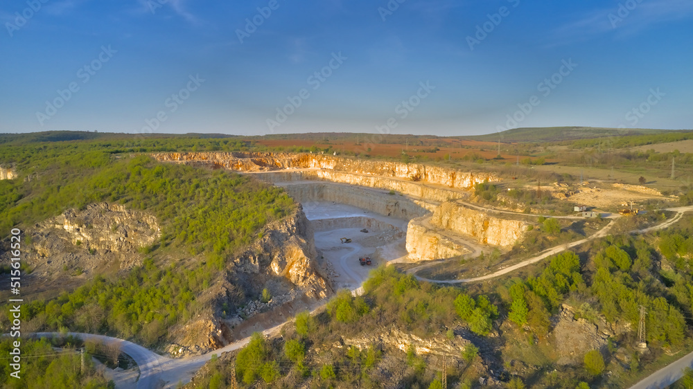 Aerial photography from a drone. View of a mining quarry aerial view at sunset