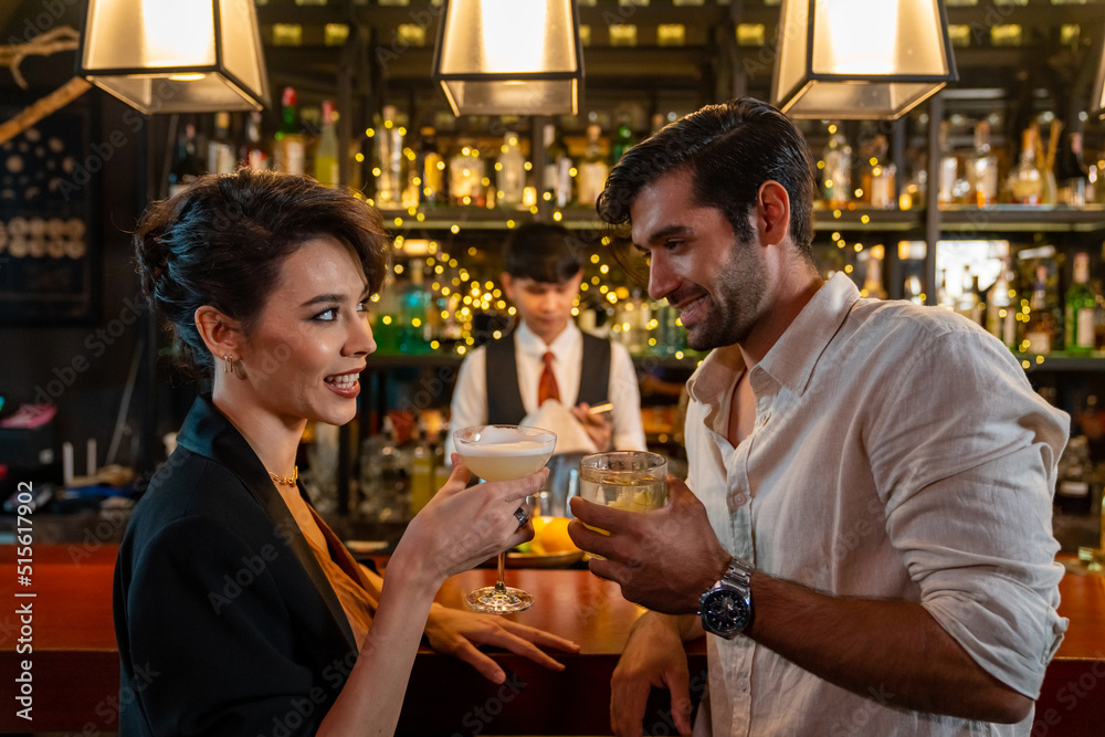 Caucasian man and woman flirting each other while hangout nightlife party at restaurant bar. Attractive female have romantic dating with boyfriend celebrating holiday event together at nightclub Caucasian man and woman flirting each other while hangout nightlife party at restaurant bar. Attractive female have romantic dating with boyfriend celebrating holiday event together at nightclub