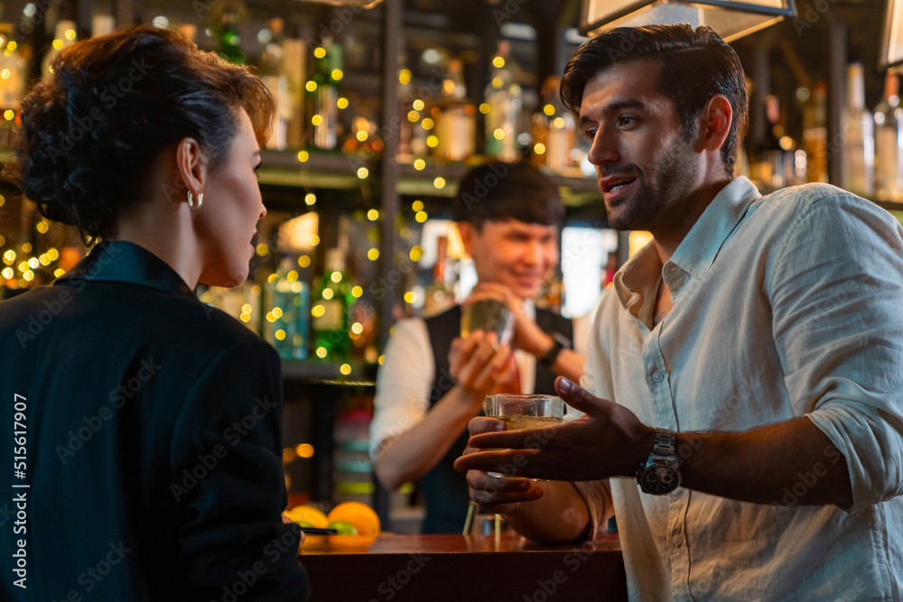 Caucasian man and woman flirting each other while hangout nightlife party at restaurant bar. Attractive female have romantic dating with boyfriend celebrating holiday event together at nightclub