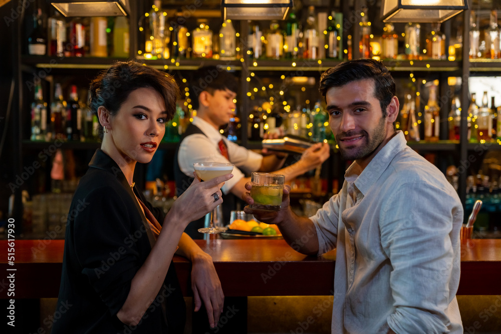 Group of People man and woman enjoy hangout nightlife meeting party with alcoholic cocktail drink at luxury restaurant bar. Male bartender preparing alcoholic drink serving to customer at nightclub