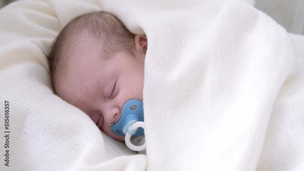 Little newborn baby boy sleeping in crib with baby dummy and teddy bear . Little newborn baby boy sleeping in crib with baby dummy and teddy bear .