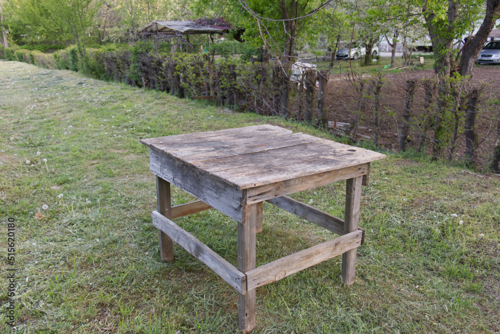 an old, worn garden table at the garden an old, worn garden table at the garden