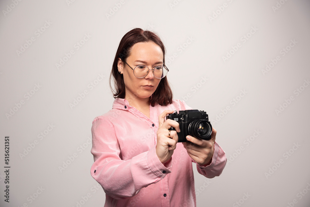 Woman looking on a camera on a white background