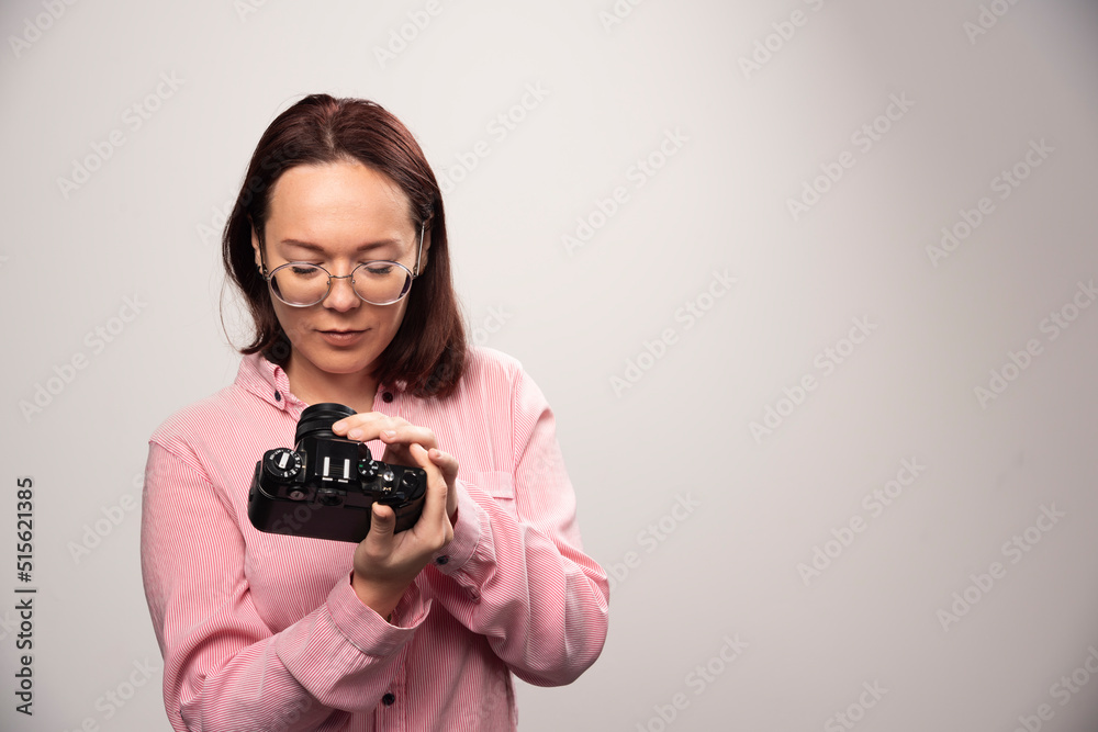 Woman looking on a camera on a white background